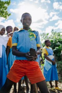 Edukans-2025-March-Malawi-Basic-Education-Eco-star-schools children students boy Sumani Umali planting tree 2 - small